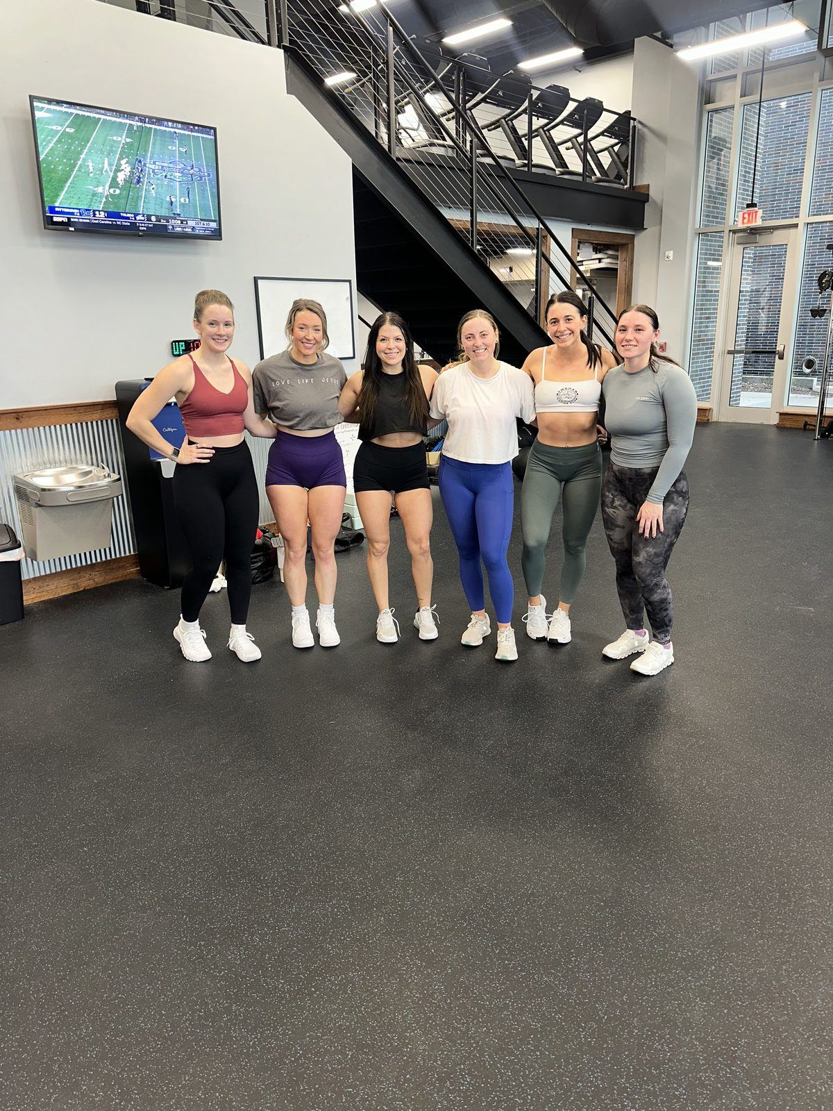 Mallory with her clients training together in the gym
